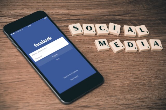 Scrabbleletters social media en een mobiele telefoon
